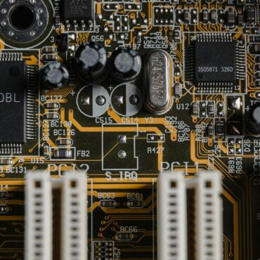 A top-down photo of a gold-plated motherboard