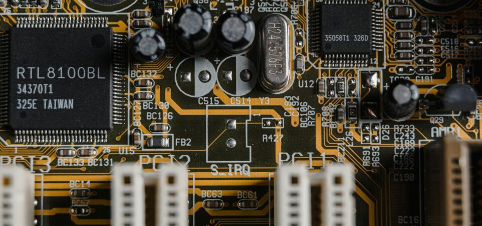A top-down photo of a gold-plated motherboard