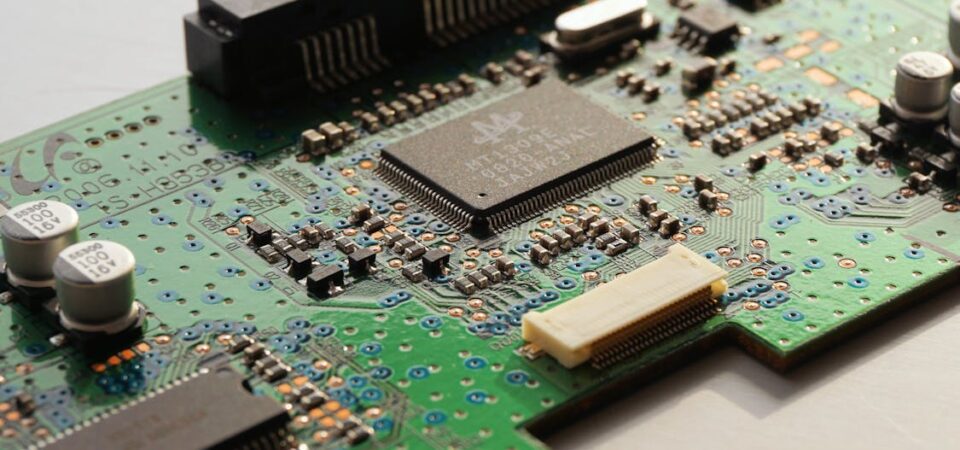 Green and black computer chip with gold components