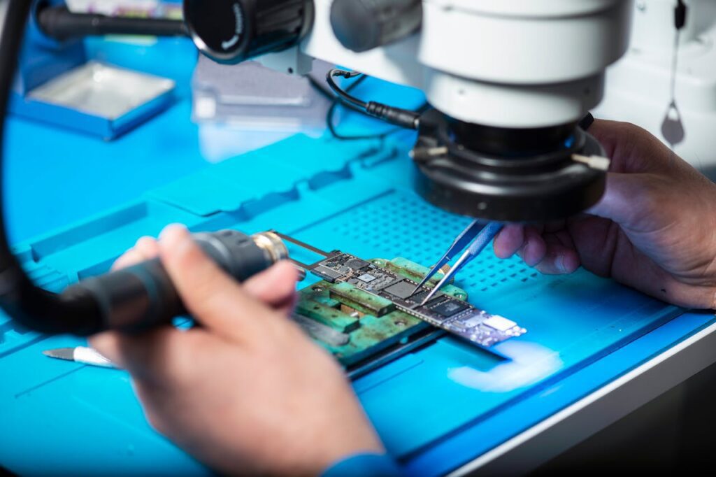 A person inspecting a finished PCB.