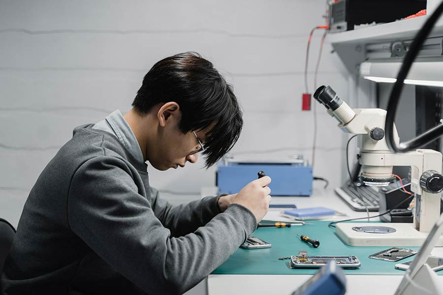 A person working on a device board.