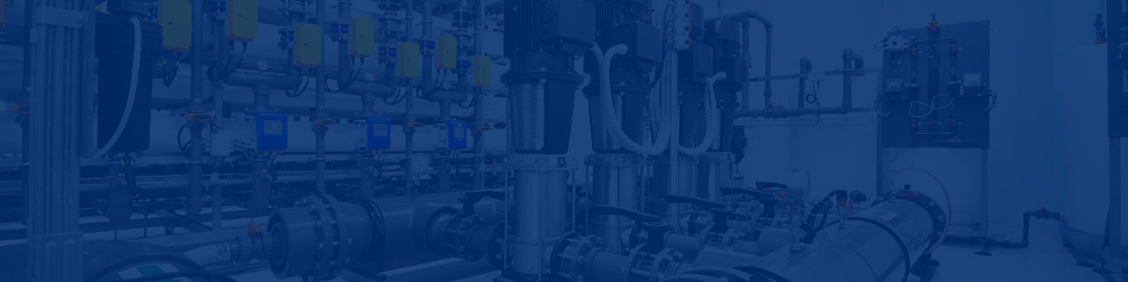 Industrial pumps, piping, and control panels in a factory setting under a blue overlay.