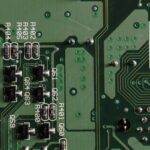 Close-up shot of a PCB showing SMT components and solder joints.
