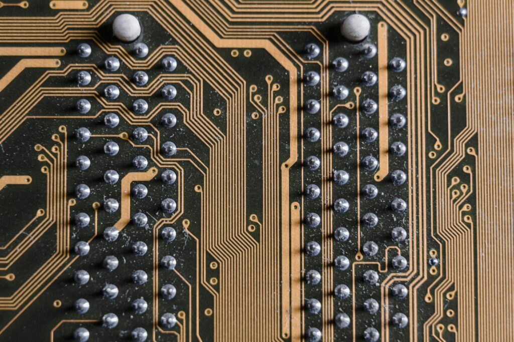 Solder joints on a PCB with gold traces.