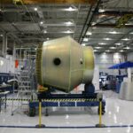 Large aerospace component positioned in a controlled manufacturing facility