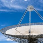 A satellite dish against a blue sky