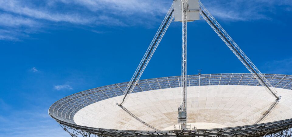 A satellite dish against a blue sky