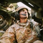 Soldier wearing headset inside a military vehicle