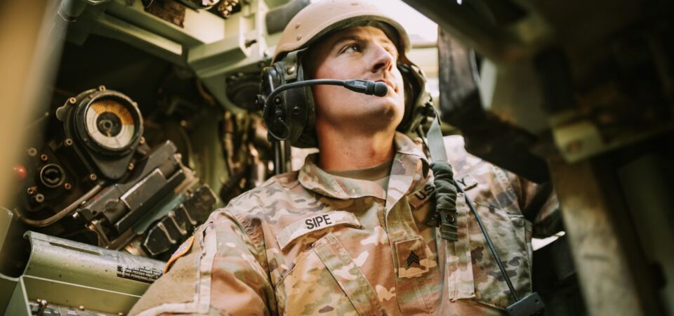 Soldier wearing headset inside a military vehicle