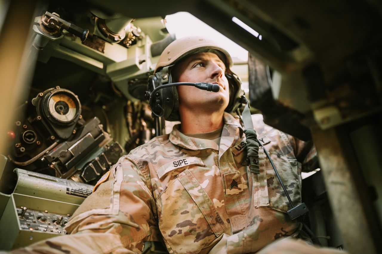 Soldier wearing headset inside a military vehicle